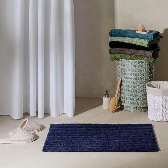https://s3-ap-southeast-2.amazonaws.com/fusionfactory.commerceconnect.bbnt.production/pim_media/000/208/067/M_F_Devon-Bath-Mat_Navy_20481410_R_LS_SI.jpg?1770170412