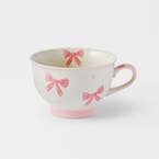 https://s3-ap-southeast-2.amazonaws.com/fusionfactory.commerceconnect.bbnt.production/pim_media/000/198/068/M_F_S25-26_Bows-Pedestal-Tea-Cup_Pink_26519801_SI.jpg?1753158850