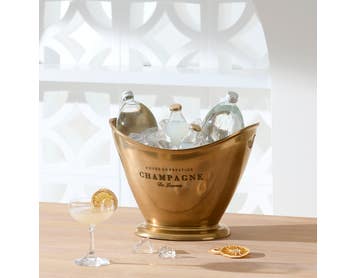 https://s3-ap-southeast-2.amazonaws.com/fusionfactory.commerceconnect.bbnt.production/pim_media/000/174/086/M_F_Summer_S24-25_LS_Studio_Barware-Champagne_Bucket_Flared_Brass.jpg?1729746510