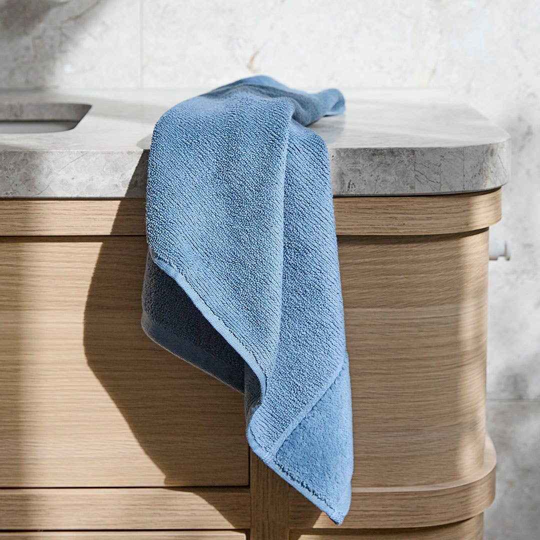 https://s3-ap-southeast-2.amazonaws.com/fusionfactory.commerceconnect.bbnt.production/pim_media/000/200/607/M_F_Summer_S25-26_LS_Bathroom_Towel-Hugo-Blue_SI.jpg?1757049074