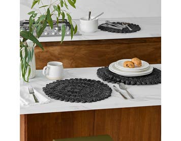 https://s3-ap-southeast-2.amazonaws.com/fusionfactory.commerceconnect.bbnt.production/pim_media/000/210/495/M_F_W26_Studio_LS_Napery_Placemats_Fancy_Florette_Centre_Pattern-Black_SI.jpg?1772503774