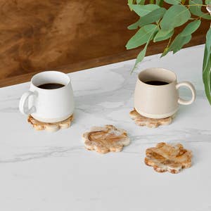 https://s3-ap-southeast-2.amazonaws.com/fusionfactory.commerceconnect.bbnt.production/pim_media/000/210/279/M_F_W26_Studio_LS_Napery_Scallop_Coaster_Resin_Coffee_SI.jpg?1771981789